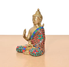 Side view Brass Buddha idol seated, raised hand; multicolor jeweled robe