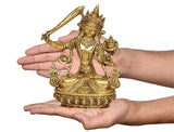 Brass Manjushree statue in hands, small tabletop deity with raised arm and crown