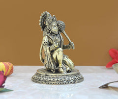 Hanuman Ji seated brass idol statue, side view with raised staff hand and ornate base