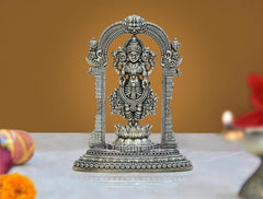 Brass Lakshmi statue figurine standing on lotus inside arched mandap