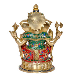 Brass Ganesha idol back view, gold silhouette, colorful robe patterns, round base
