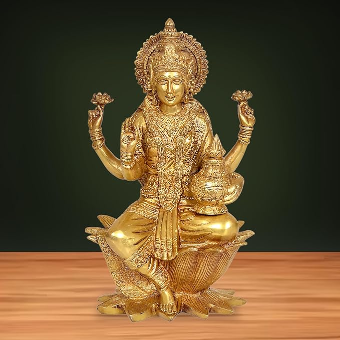 Brass Lakshmi idol statue with four raised hands, seated on lotus base