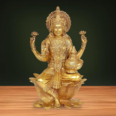 Brass Lakshmi idol statue with four raised hands, seated on lotus base