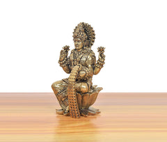 Bronze Lakshmi idol on lotus, side view showing four arms and beaded garland