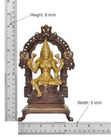 Brass Lakshmi idol statue on pedestal, centered with gold figure and dark arch