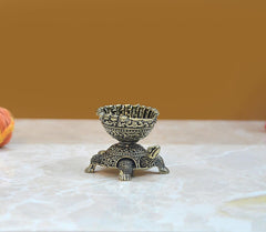 Brass tortoise oil lamp diya with ornate bowl rim, small feet and engraved pattern