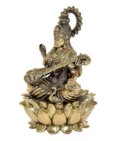Brass Saraswati figurine seated on lotus, holding veena, detailed ornaments