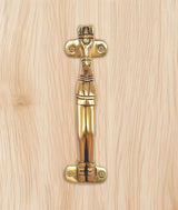 Gold brass horse head door handle close-up with engraved details and screw heads