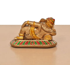 Back/side of relaxing Ganesha resin statue, gold-toned attire and striped base pattern