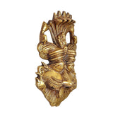 Brass Kirtimukha wall hanging shown in side profile, textured deity mask