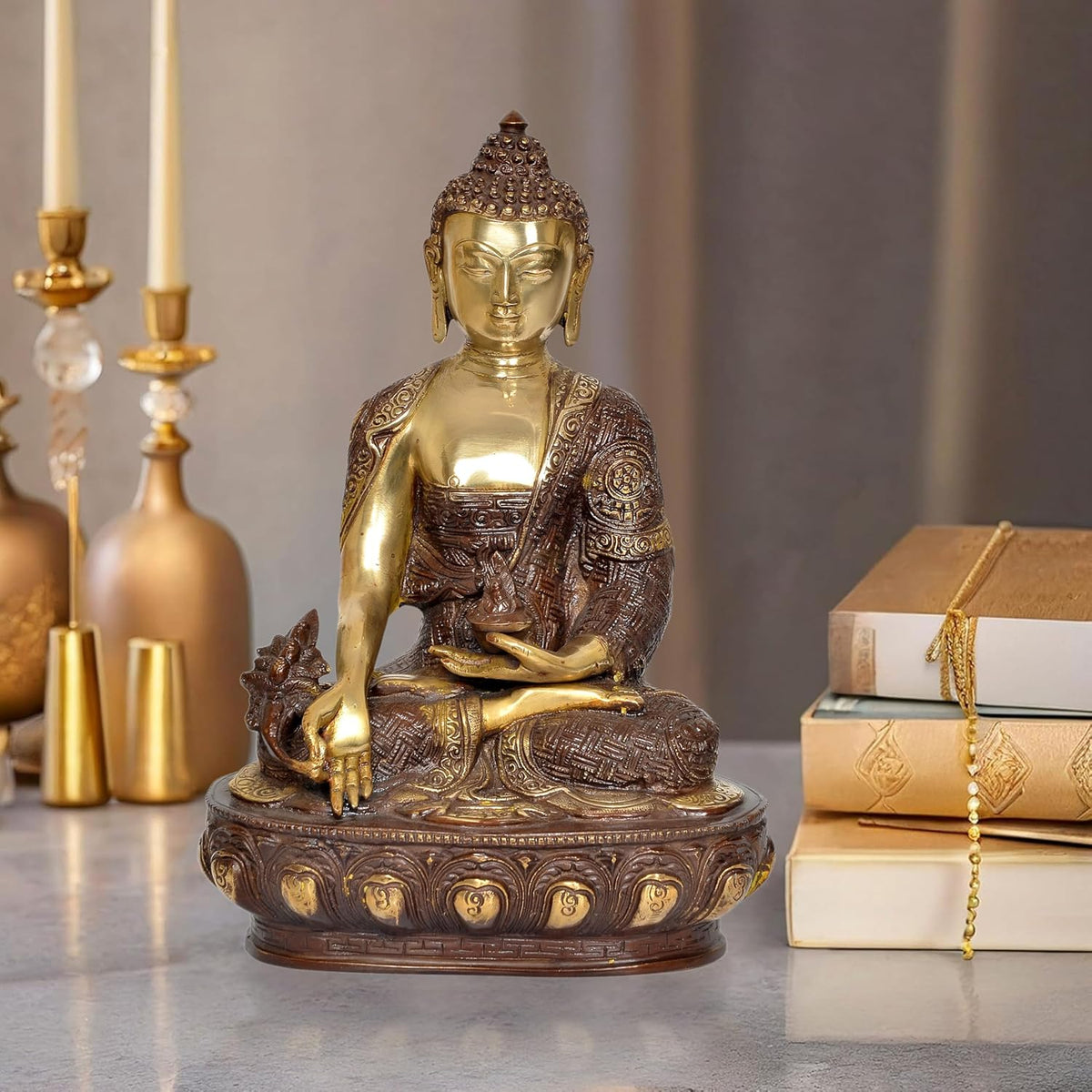 Brass Buddha statue in dhyan mudra, gold face and bronze robe, seated on ornate base