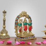 Brass Darbar idol, side view of three figures with red and green garments