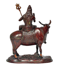 Close-up of Shiva seated on Nandi statue, detailed trident and patterned robe saddle