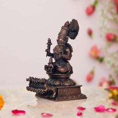 Copper Surya Dev Rath idol, side view, seated figure holding a staff, 4.5 in