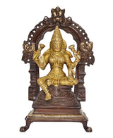 Seated Lakshmi brass statue with raised hands and dark arched halo frame