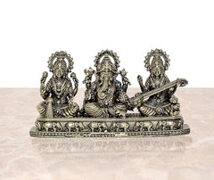 Three-piece brass Ganesha Lakshmi Saraswati idol set with detailed pedestal base