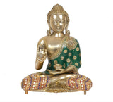 Brass seated Buddha idol with Abhaya mudra hand, green robe, decorated multicolor seat