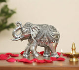Silver elephant figurine, 3-inch height, ornate engraved details, side view.