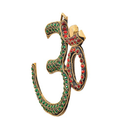 Brass OM wall hanging front view with green and red studded detailing