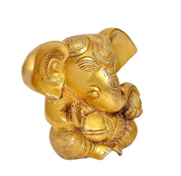 Brass Ganesha idol statue, angled view showing face and trunk detail