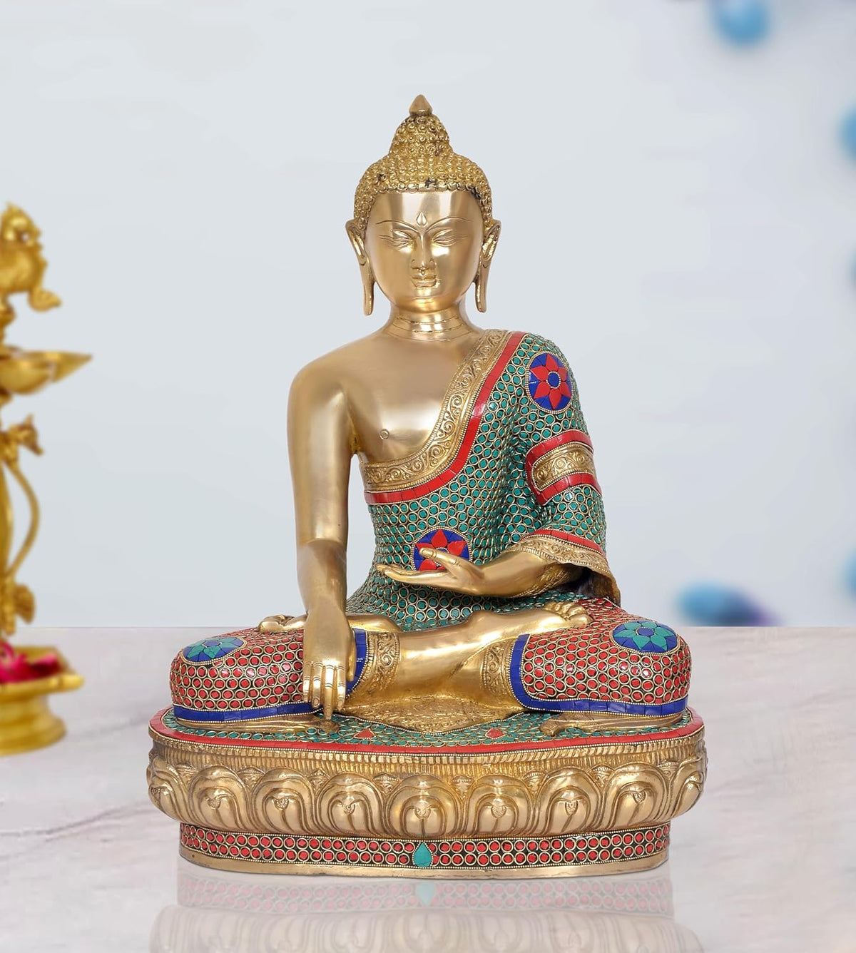 Brass meditating Buddha statue, seated in dhyan mudra, teal red mosaic robe