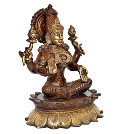 Brass Lakshmi idol statue, angled view showing gold ornaments and raised hands
