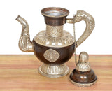 Brass teapot showpiece, side view: engraved body, silver spout, and round lid