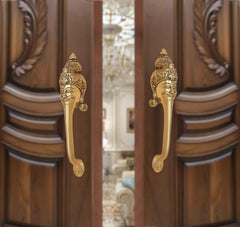 Brass long-neck door handle pair with ornate face heads, golden finish