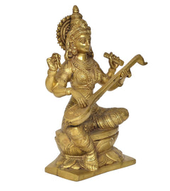 Brass Saraswati statue angled view, seated with veena and raised blessing hand
