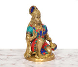 Brass Hanuman Ji sitting murti, angled view, colorful beaded jewelry and robe
