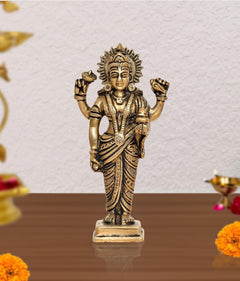 Brass Dhanvantri statue with raised hands, ornate crown, standing figure on pedestal