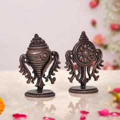 Copper Sanghu and Chakram deity figurines, front-facing view with circular chakram motif