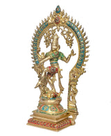 Side view brass Shiva idol with teal halo, multicolor ornaments on arms and torso