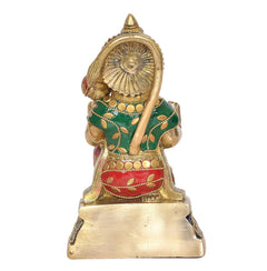 Brass Hanuman Ji close-up statue, gold face, blue headpiece, green tunic with red details