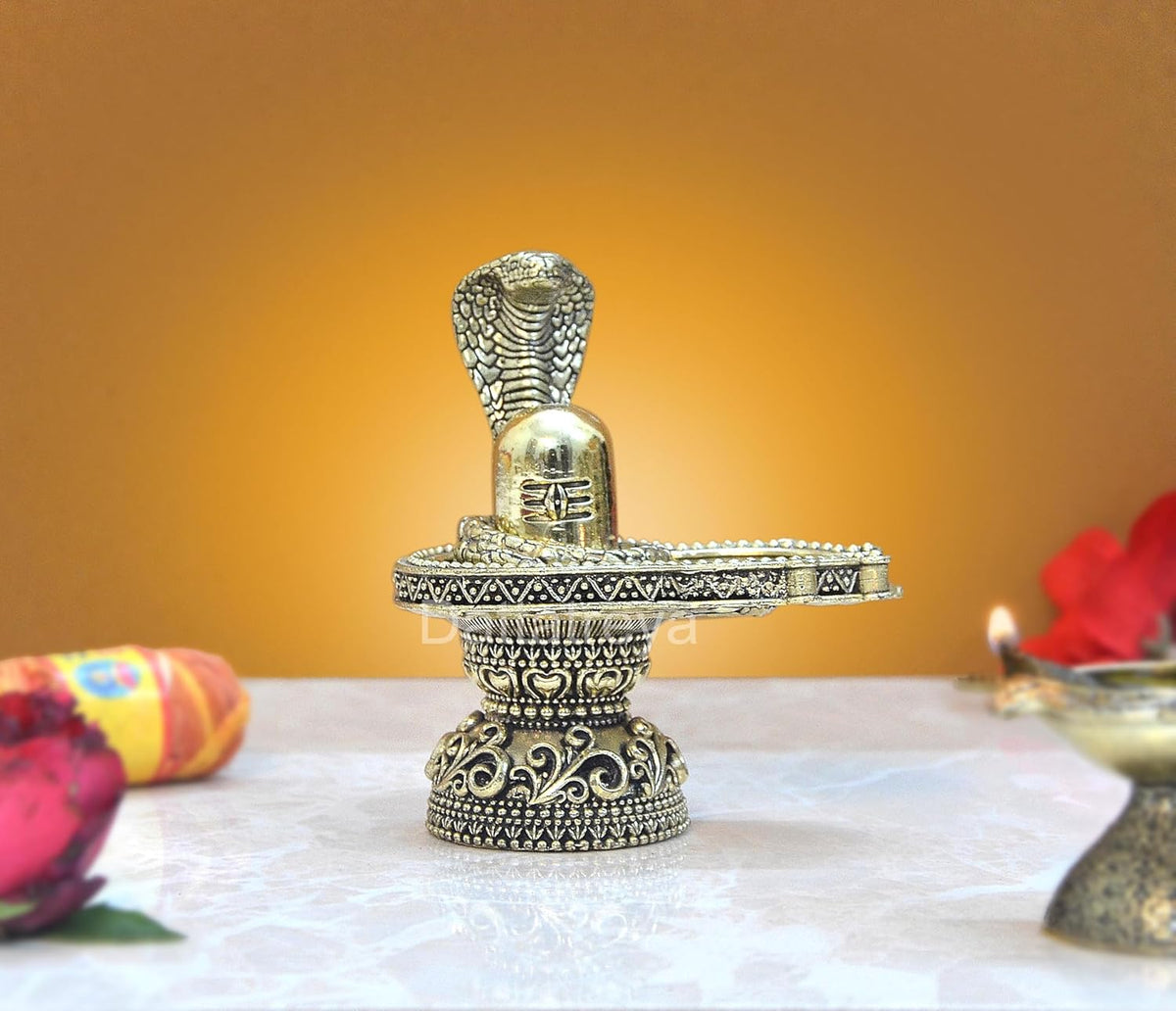 Brass shivling figurine with cobra hood and ornate pedestal, height 4 inch.