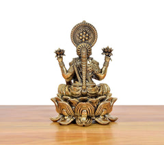 Back view of brass Lakshmi on lotus, detailed crown and beaded arms