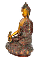 Buddha-Statue im Meditationssitz, Profilansicht, goldene Figur mit grünroten Ornamenten
