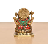 Back view brass Ganesha statue, jeweled shoulders and red skirt; detailed circular halo