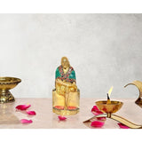 5-inch brass Sai Baba statue, seated, green robe with red jewelry details
