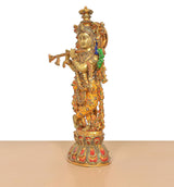 Side view brass Krishna idol showing flute and jeweled Meenakari drapery