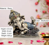 Baby Ganesha resin idol with detailed crown, blue cloth wrap, and bowl of beads