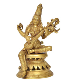 Brass Saraswati statue seated with veena, raised hands and detailed crown, ornate base