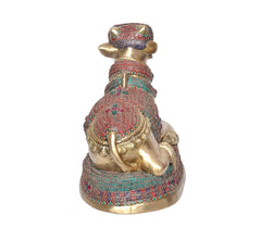 Back view of seated Nandi bull statue in brass with teal and red mosaic trim