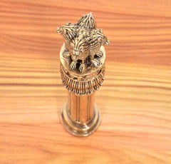 Close-up of bronze Ashoka finial top: lion detail on circular engraved ring