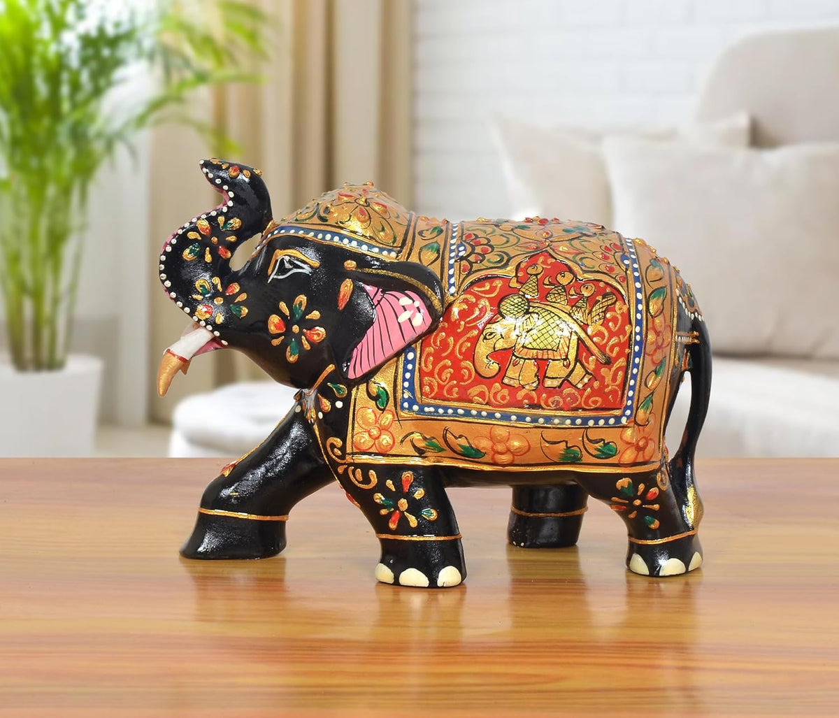Wooden elephant showpiece, black with red patterned body and painted gold details