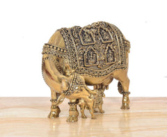 Brass cow with calf figurine, rear 3/4 view, decorative engravings and tail