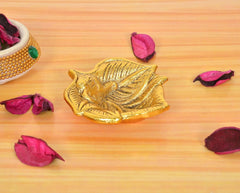 Golden metal oil diya lamp with stylized bird design on base; height 1 inch