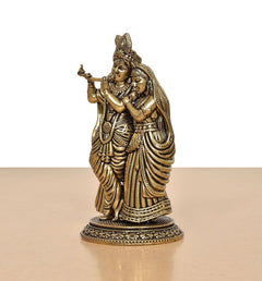 Superfine brass Radha Krishna idol, side view, raised flute hand and draped garments