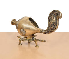 Brass shankh conch on tripod stand with engraved panels along the curved neck