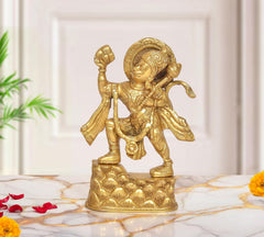 Brass Hanuman idol with mountain base, standing with one arm raised and tail curled